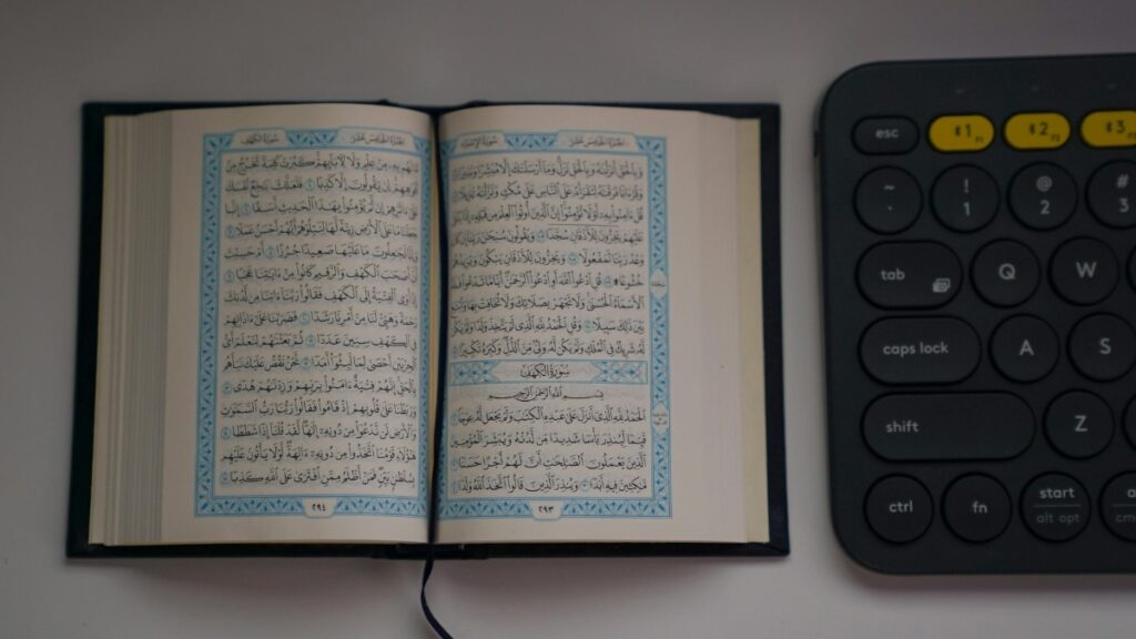 Human text juxtaposed with a keyboard. Human language has its origins in culture, abstraction and human experience, whereas machine language functions off mathematical rules.