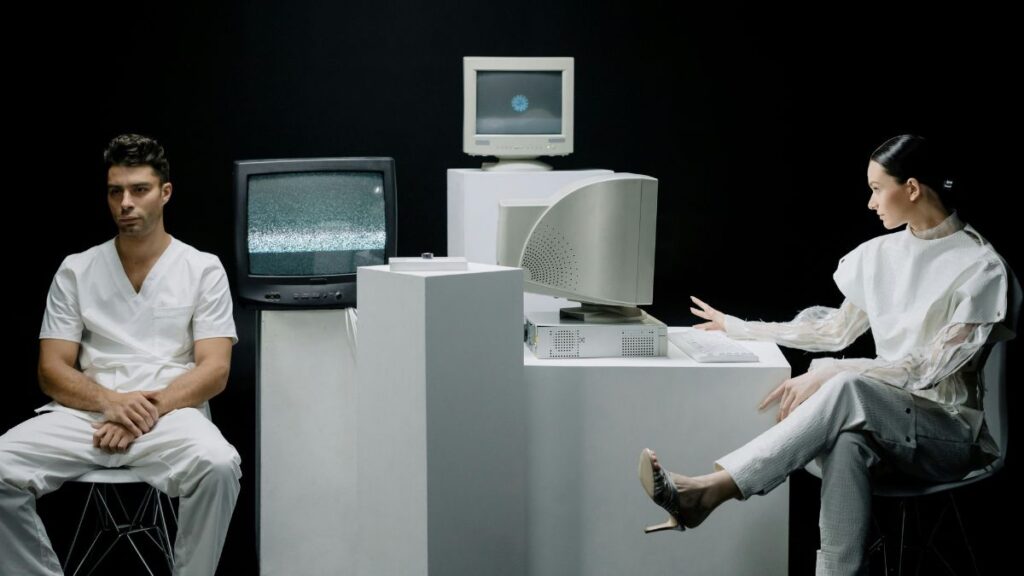 Two data scientists sit behind computers. The ecosystem.Ai Prediction Platform ensures data scientists remain satisfied with their work.